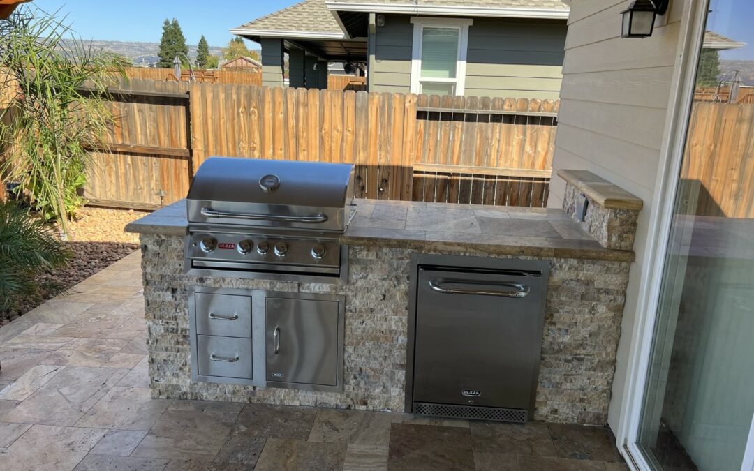 outdoor kitchen next to new swimming pool built by Emerald Pools